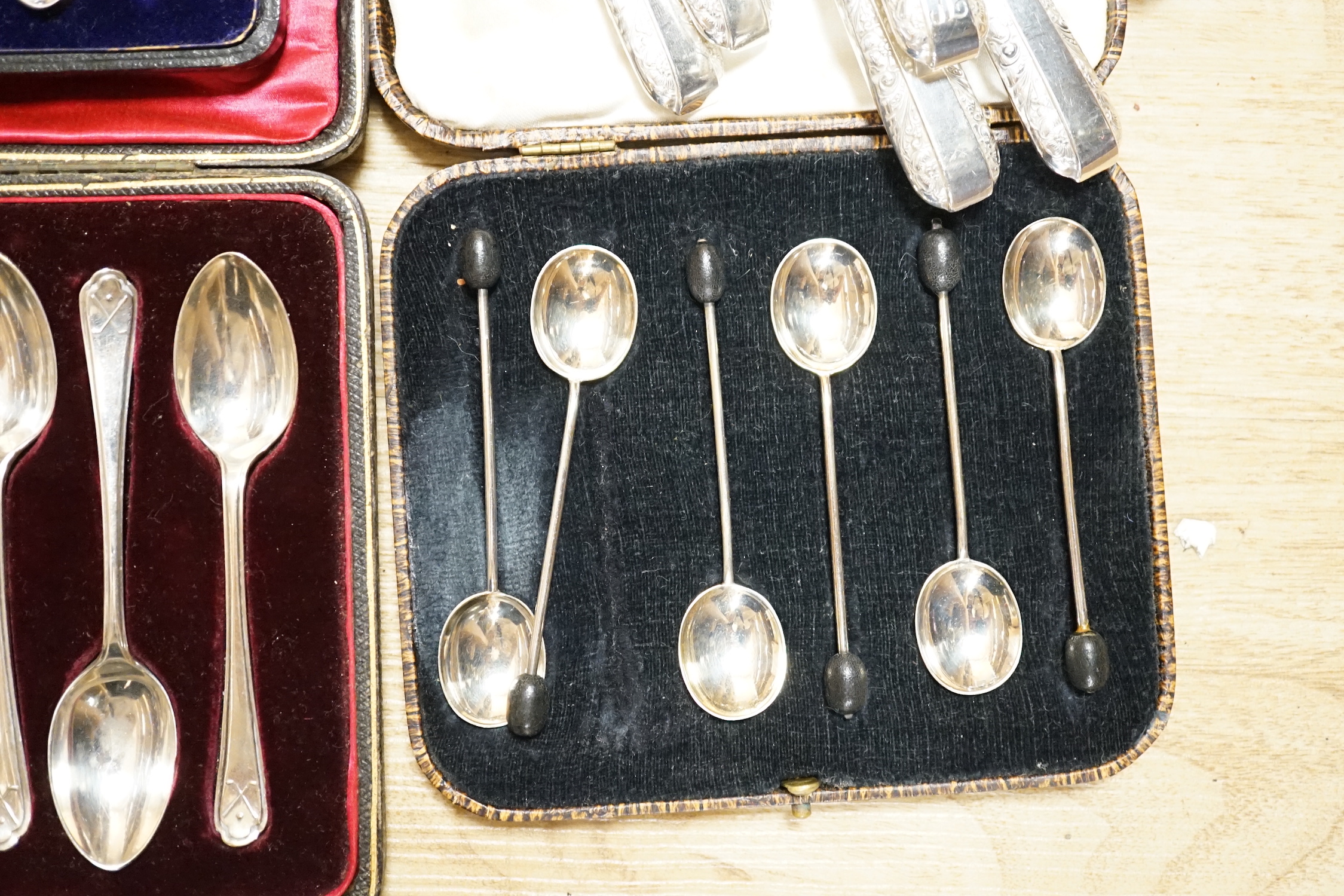 A cased set of six George V silver and polychrome enamel coffee spoons, Barker Brothers Silver Ltd, Birmingham, 1932, four other cased sets including teaspoons and tea knives and seventeen assorted Towle sterling handled